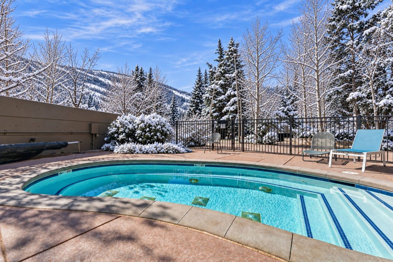 Shared indoor pool & hot tub with lounge chairs