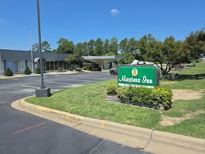 A parking lot with a sign for Masters Inn Economy.