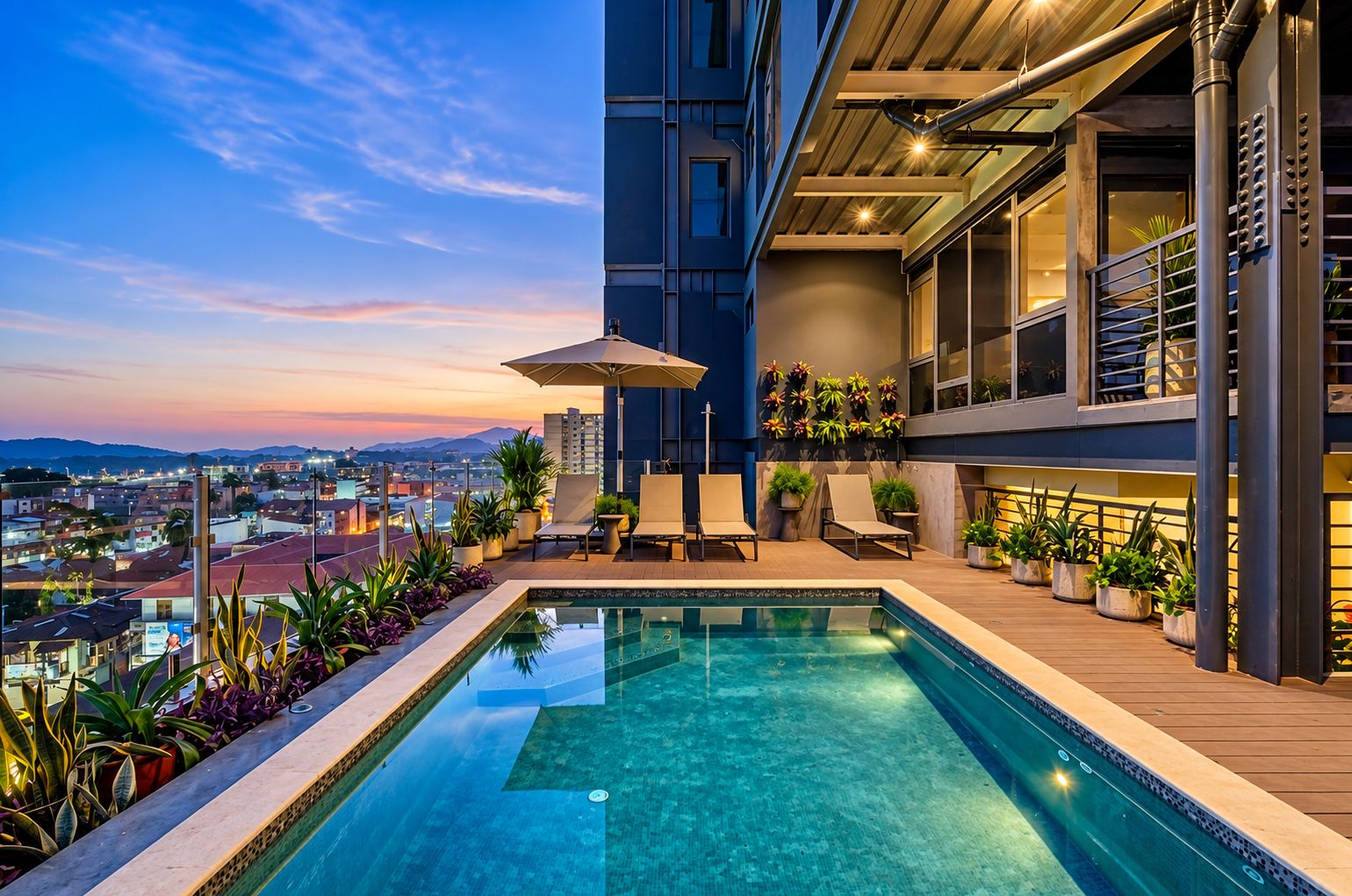 A rooftop pool with a view of the cityscape, lounge chairs, and potted plants.
