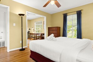 A hotel room with a bed, a desk, a dresser, and a ceiling fan. - Eclectic South Austin Home w Flex Studio Room & Covered Patio (Austin)