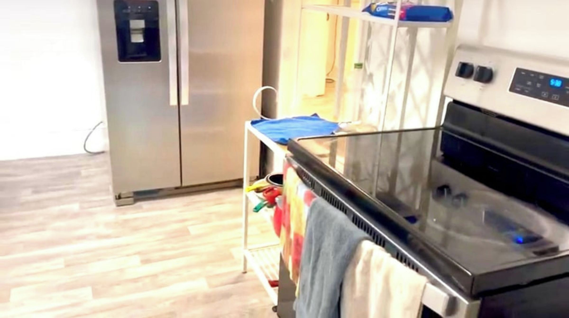 A kitchen with a stainless steel refrigerator, a microwave, and a stove.