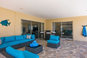 An outdoor patio with a sofa set, a coffee table, and a wall-mounted coat rack. - 3-bedroom house in Seminole with lanai and temperature controlled pool. (Seminole)
