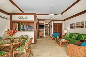 A hotel room with a dining area, kitchenette, and a living room with a sofa and chairs. - Kiahuna 115 - Ground Floor - Corner Unit - Two ACs (Koloa)