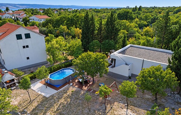 A residential area with a swimming pool, a barbecue area, and a view of a forested landscape. - Awesome home in Seline with WiFi (Seline)