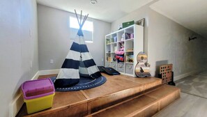 A play area with a teepee, storage shelves, and a toy guitar. - Flagstaff Family Home with Playroom & Snowbowl (Flagstaff)