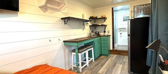Peaceful, one-bedroom, boho-style cabin is in the woods in Quitman, Arkansas.