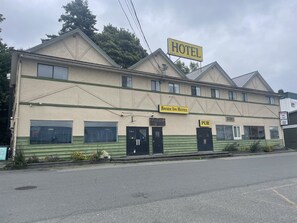 A two-story building with a sign indicating it is a hotel and a pub.