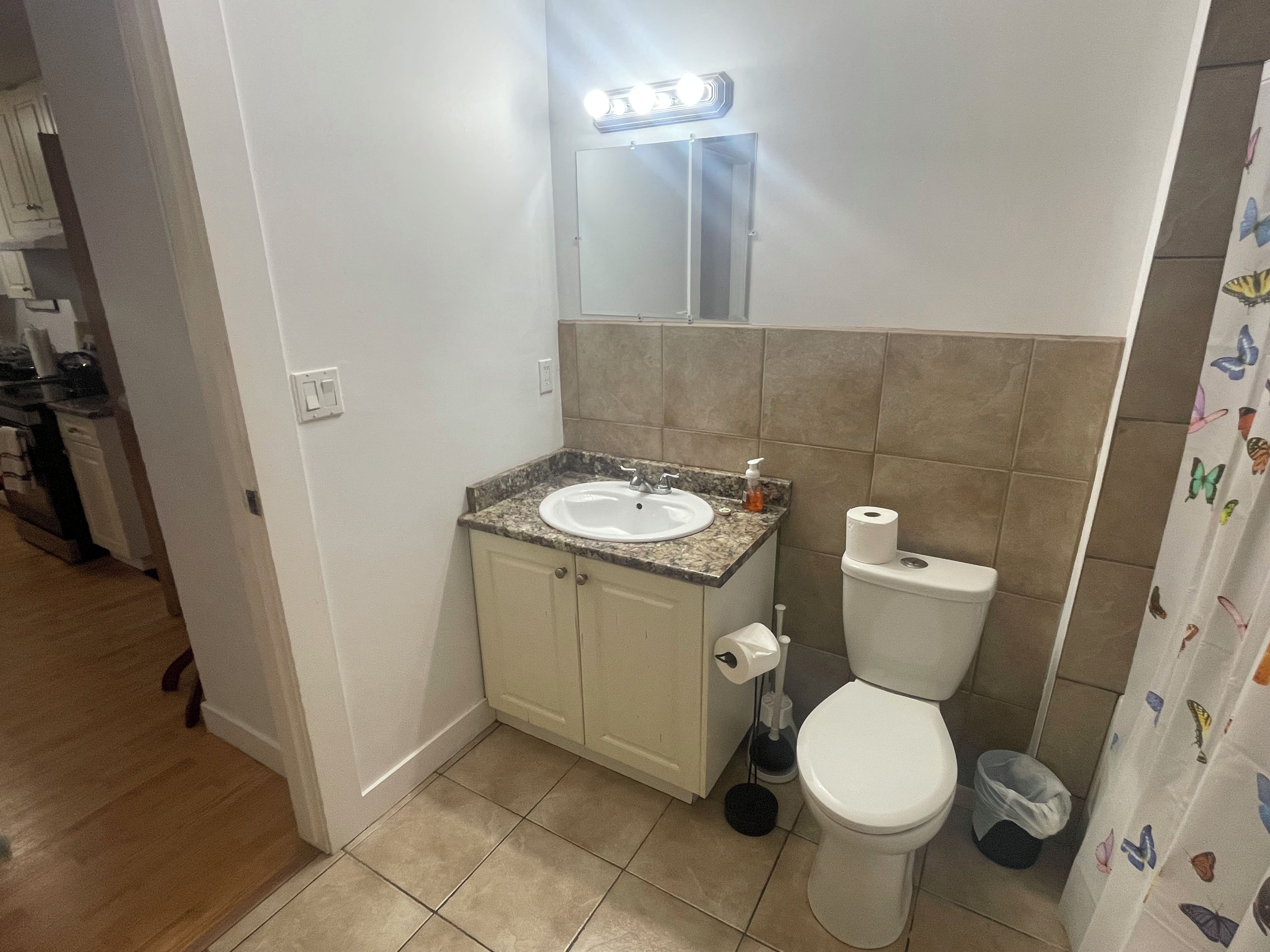 Un baño con lavamanos, inodoro y tocador.