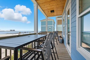 A covered outdoor deck with a view of the ocean and a pier. - Beachfront Paradise 3BR/3BA Park & Casino (Gulfport)