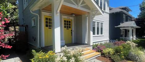A two-story house with a porch and a front yard.