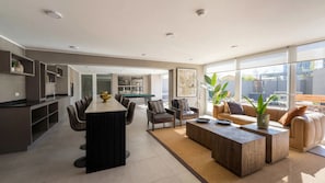 A modern living space with a kitchen, dining area, and seating area. - Edificio Froilan Lagos by Domus Travels (La Florida)
