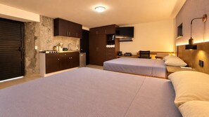 A hotel room with two beds, a kitchenette, a TV, and a coffee bar. - Bowra Suite Privada 7, Colonia Americana (Guadalajara)
