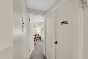 A hallway leading to a bedroom with a door marked 'Restrooms.' - Spacious Taylorsville Home w Finished Basement! (Taylorsville)