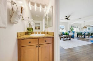 A bathroom with a wooden vanity, a sink, and a mirror. - La Jolla Beach House -  Walk to Windansea, EV Charger (San Diego)