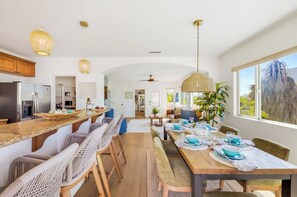 A spacious kitchen with a long island, modern appliances, and a view to the outside. - La Jolla Beach House -  Walk to Windansea, EV Charger (San Diego)