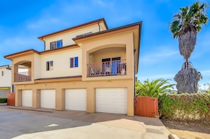 A two-story house with a garage, a balcony, and a palm tree. - La Jolla Beach House -  Walk to Windansea, EV Charger (San Diego)