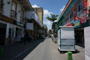 A street with buildings, including a hotel with a sign that says 'HOTEL' and a store with a sign that says 'AMIGA'. - Hotel Arte  (SANTA ROSA DE CABAL)
