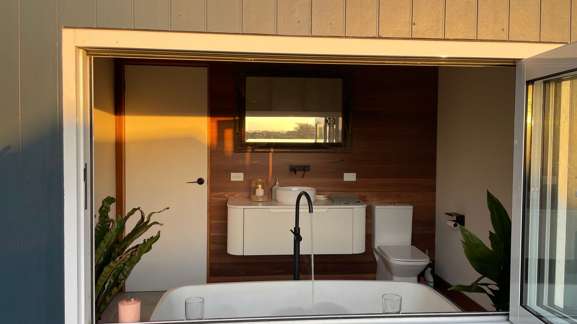 A modern bathroom with a bathtub, sink, and toilet.