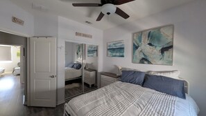 A bedroom with a bed, a dresser, a nightstand, a ceiling fan, and artwork on the walls. - 3-story Serene Surf Loft in perfect Imperial Beach with AC (Imperial Beach)