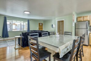 A dining area with a table, chairs, and a sofa. - Knox & Pine  3BR Tahoe Home Fireplace & Garage (South Lake Tahoe)
