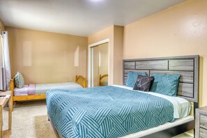 A bedroom with two beds, a desk, and a chair. - Knox & Pine  3BR Tahoe Home Fireplace & Garage (South Lake Tahoe)