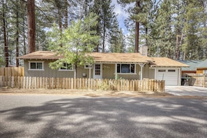 A single-story house with a gabled roof, a front porch, and a garage. - Knox & Pine  3BR Tahoe Home Fireplace & Garage (South Lake Tahoe)