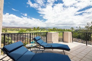 Spacious lanai with seating, offering beautiful views of the lush surroundings and direct access to the nearby tennis courts. - new Luxury Ocean View Penthouse (Waikoloa Village)