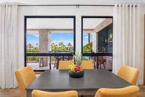 The stylish dining area is perfect for enjoying meals together, featuring a spacious table that comfortably seats your group and enhances your dining experience. - new Luxury Ocean View Penthouse (Waikoloa Village)