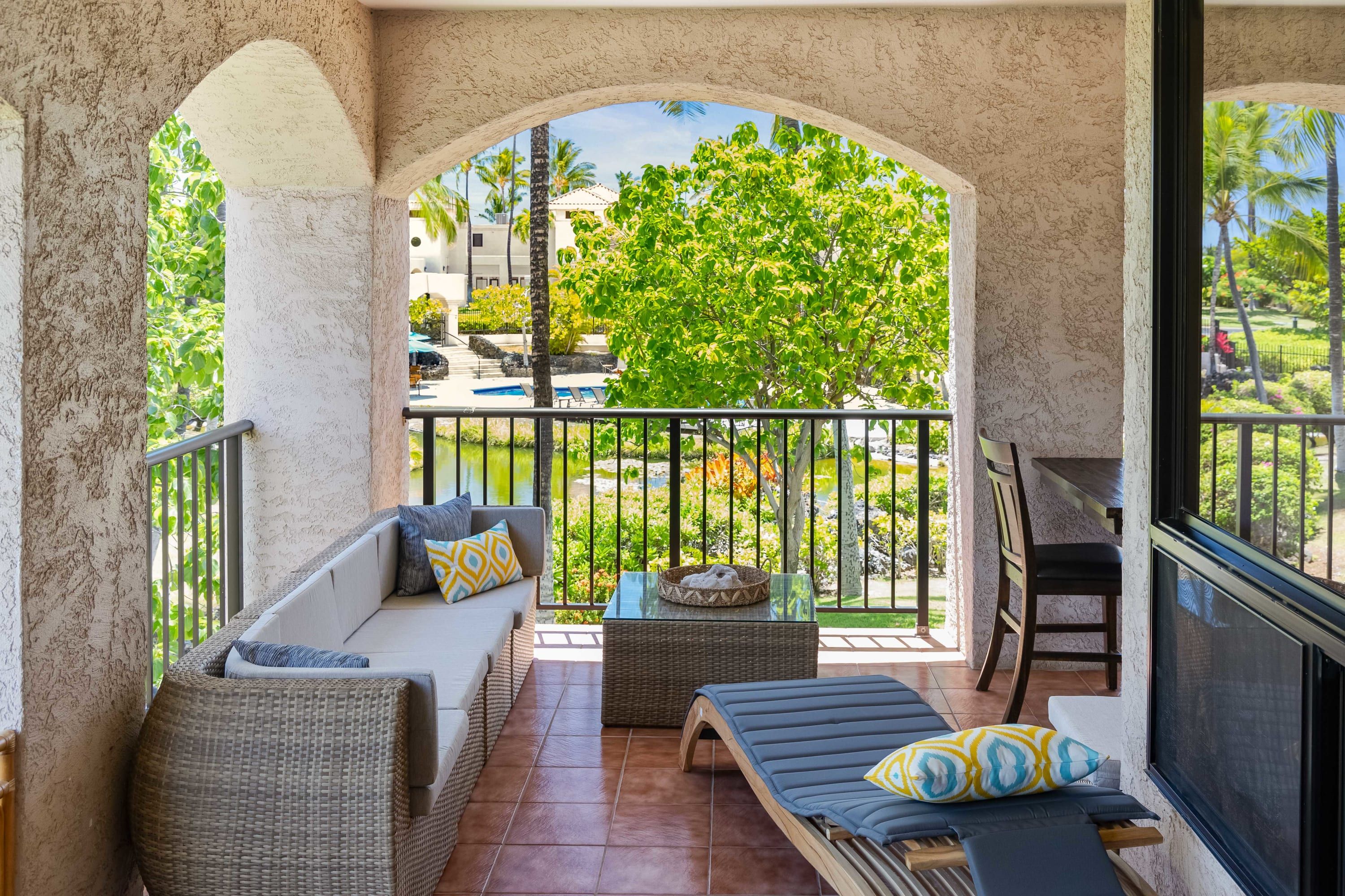 Oversized wrap-around lanai has resort views and gives a tropical vibe. Yours to enjoy are loungers, seating area, wet bar, as well as a bar-high table overlooking the resort pool. 