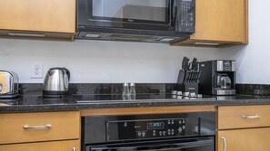 A kitchen with a microwave, coffee maker, toaster, and dishwasher. - Near Disney at Encantada Resort Cozy Townhouse (Kissimmee)