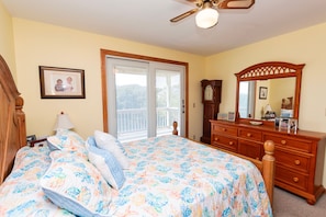 A bedroom with a bed, dresser, and a ceiling fan. - Oceanside- Near Ocean, Priv Pool, Close to Shopping-SH110 (Duck)