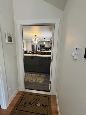 Eine moderne Küche mit dunklen Schränken, einem Edelstahlkühlschrank und einer Mikrowelle.