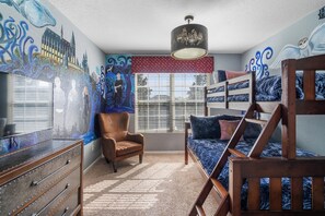 A room with bunk beds, a chair, a dresser, and a window with blinds. - Stunning 5 Bedroom Oasis in Kissimmee, 6685 (Orlando)