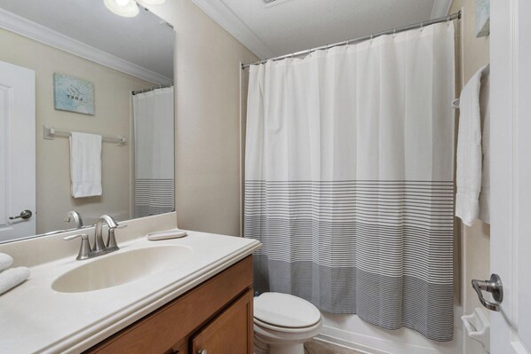 A bathroom with a double sink, a toilet, and a shower curtain. - Charming 6 Bedroom House in Kissimmee, 6686 (Orlando)