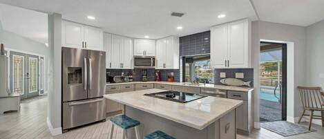 Beautiful, fully-equipped kitchen with new appliances. Kitchen island seats 2
