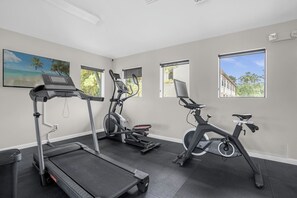 A fitness room with treadmills, elliptical machines, and stationary bikes. - Modern 4 Bedroom Townhome in Downtown Orlando, 6687 (Orlando)