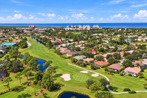 A residential area with houses, a golf course, and a body of water. - Serenity in Punta Gorda, 1003 (Cape Coral)