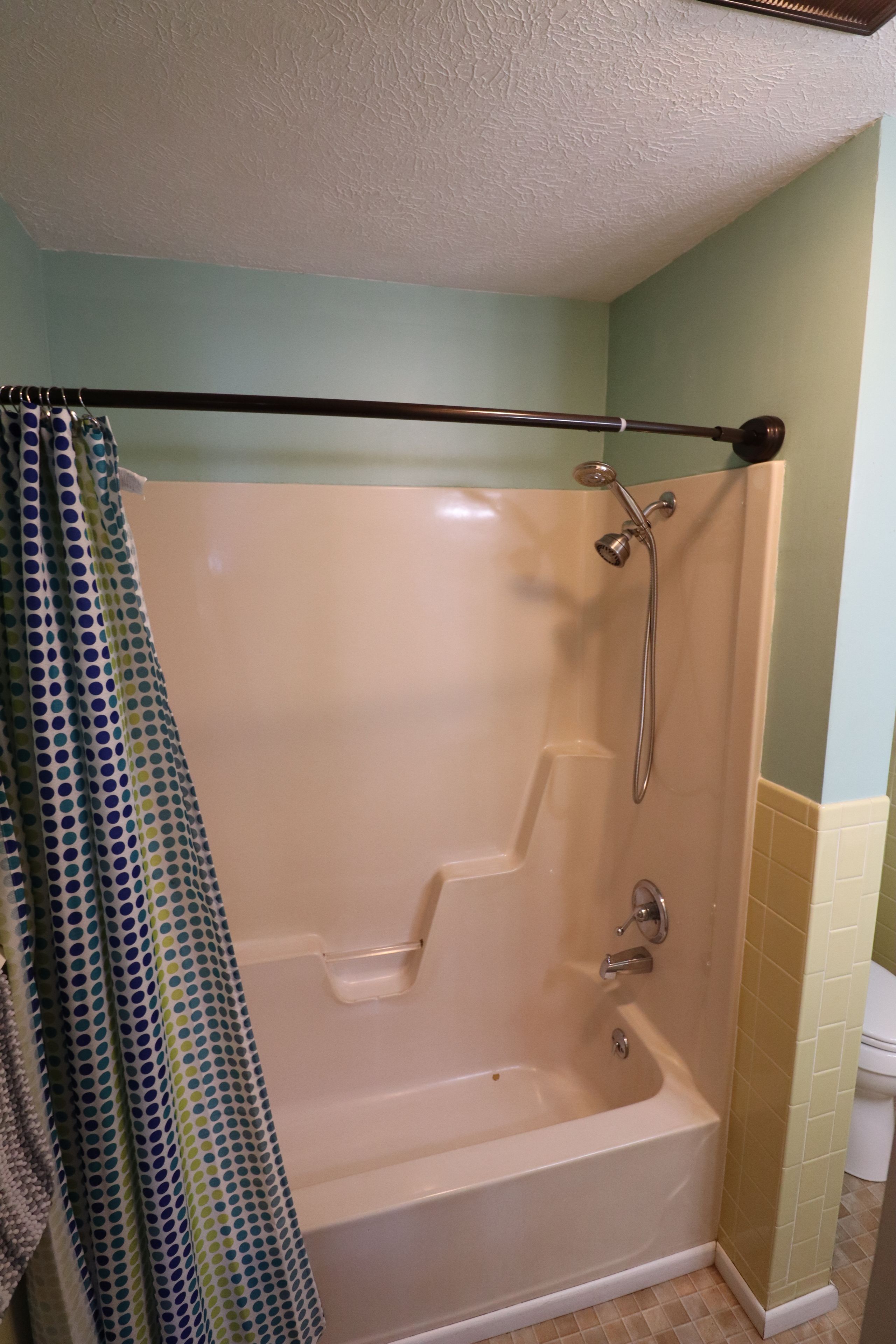 A bathroom with a shower, a bathtub, and a toilet.