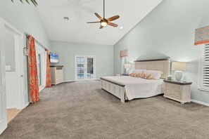 Primary bedroom features a king bed, lanai access, beautiful en suite, and 48-inch Smart TV - Modern Urban Retreat in Englewood, 1008 (Sarasota County)