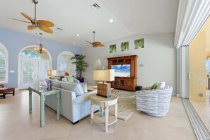 Large open living space overlooking the pool &amp; canal beyond. Living room features lots of seating and 65-inch Smart TV - Cozy 3 Bedroom Home in Punta Gorda, 5941 (Charlotte County)