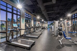 A gym with treadmills, weight machines, and cardio equipment. - Luxurious 9 Bedroom Mansion in Kissimmee, 6704 (Orlando)
