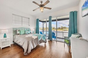 Upstairs guest bedroom 1 with queen bed, balcony access and 32" Smart TV - Modern Oasis in Port Charlotte, 5940 (Charlotte County)