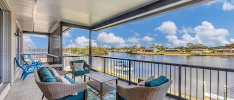Balcony overlooking pool and water