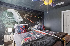 A bedroom with a Star Wars theme, including a mural, pillows, and bedding with Star Wars characters. - Stunning 8 Bedroom House in Davenport City, 6692 (Orlando)
