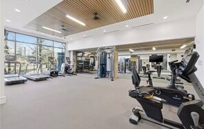 A gym with treadmills, exercise equipment, and large windows. - Midtown Atlanta 2 bedroom luxury condo (Atlanta)