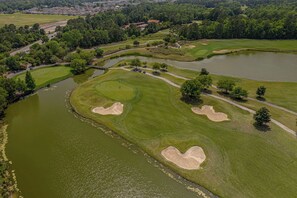 An aerial view of a golf course with multiple bunkers and water hazards. - Ocean Dunes Tower I | Ocean View | Pool | Sleeps 6 (Myrtle Beach)
