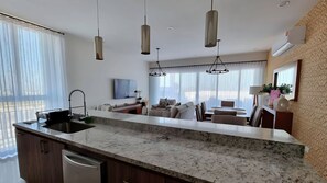 A modern kitchen with a granite countertop, stainless steel appliances, and pendant lighting. - Spacious 3-bedroom Penthouse,with a beautiful view in fabulous San José del Cabo (San José del Cabo)