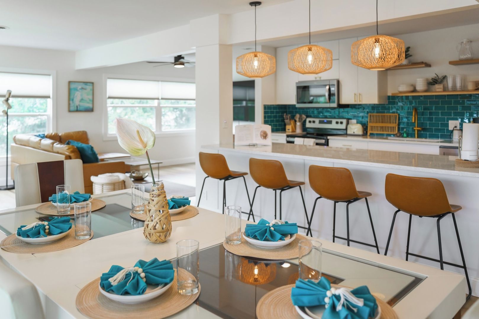 A modern kitchen with a central island, bar seating, and pendant lighting.