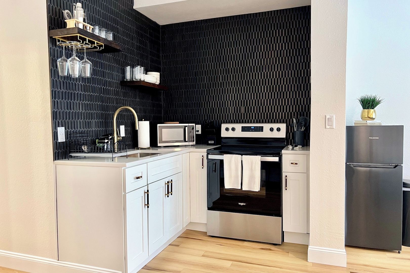 A compact kitchen with a microwave, stove, and refrigerator.
