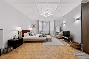 A modern bedroom with a large bed, bedside tables, a TV, and a ceiling light fixture. - Holland Park 5BR Sauna Garden Parking (London)